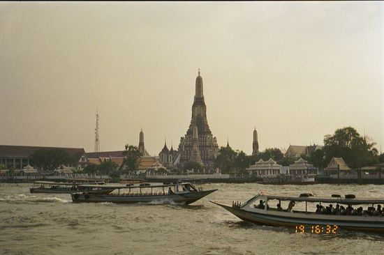 Wat Arun, ein pagodenähnlicher Turm von mehr als 80 Meter Hoehe, direkt am Chao Phraya River.
