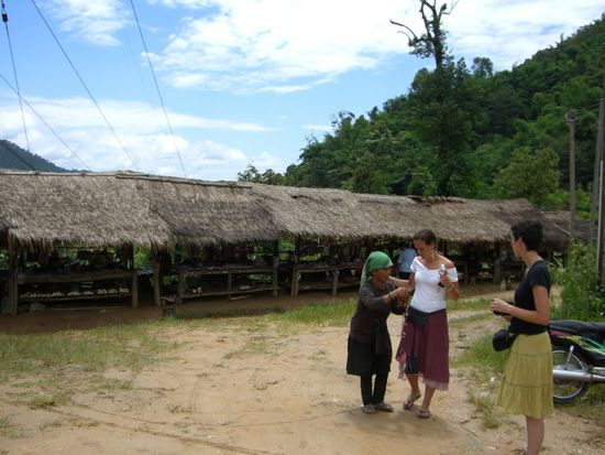 Unser zweiter Halt beim Dorf der AKHA - unsere zwei Belgierienen werden gleich von der ersten Frau überfallen, die was verkaufen will.
Und hier sind wir erst am Eingang zum Dorf, jetzt geht's den Berg runter!
